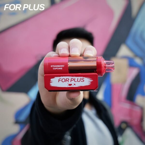 Hand holding a red FOR PLUS 50000 Puffs 50k disposable vape kit in front of a colorful graffiti wall background.
